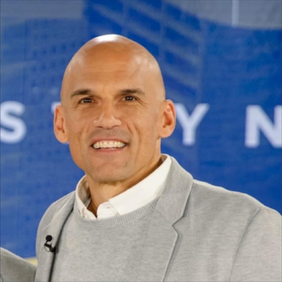 Jesse Bradley smiling in a grey blazer