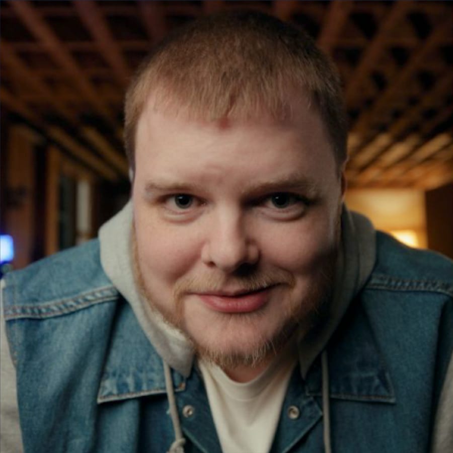 Stewart Freeman in a denim jacket, smiling toward the camera