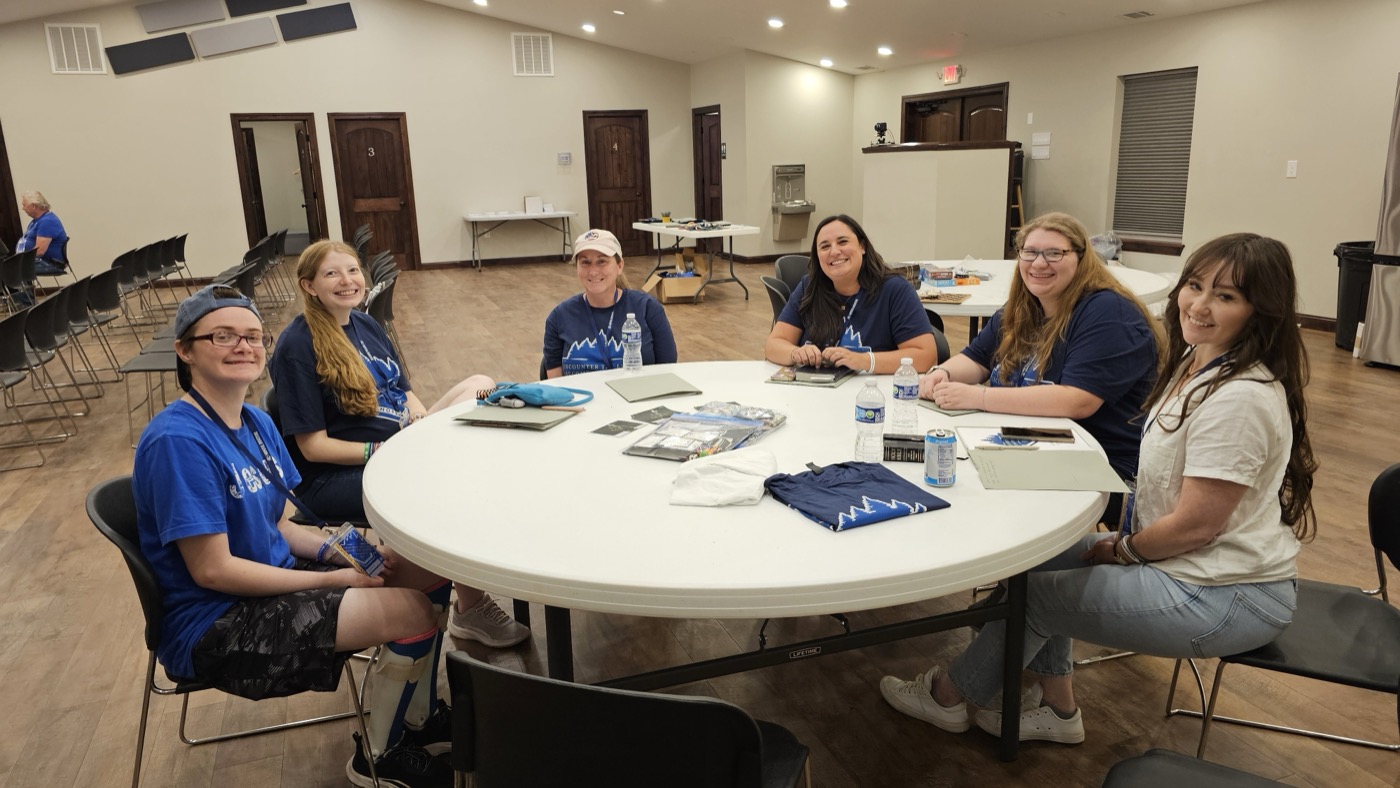 Women from the His Daughters group around a table together at HopeCon