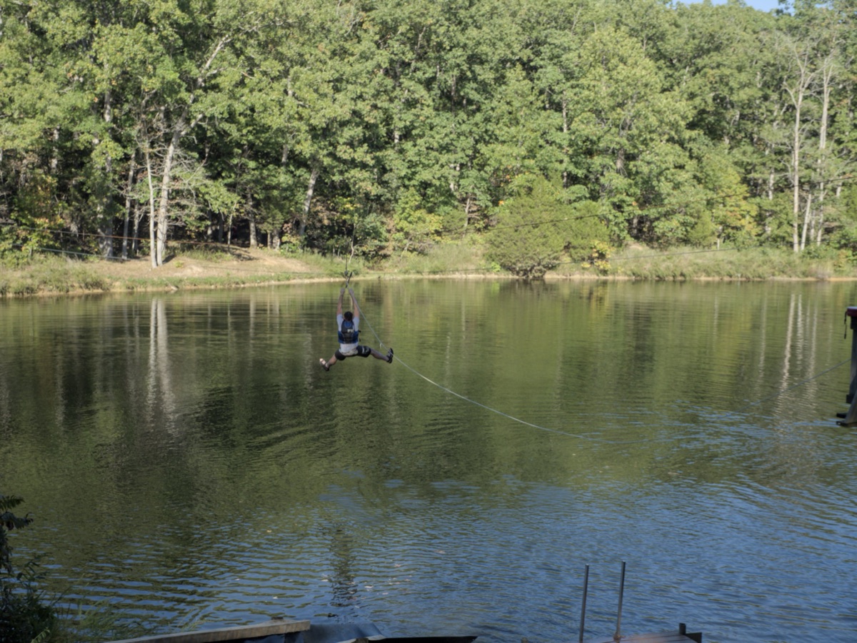 Riding the zipline across the lake