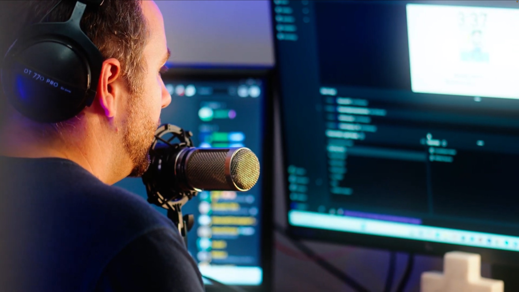 A Digital Missionary speaking into a studio microphone